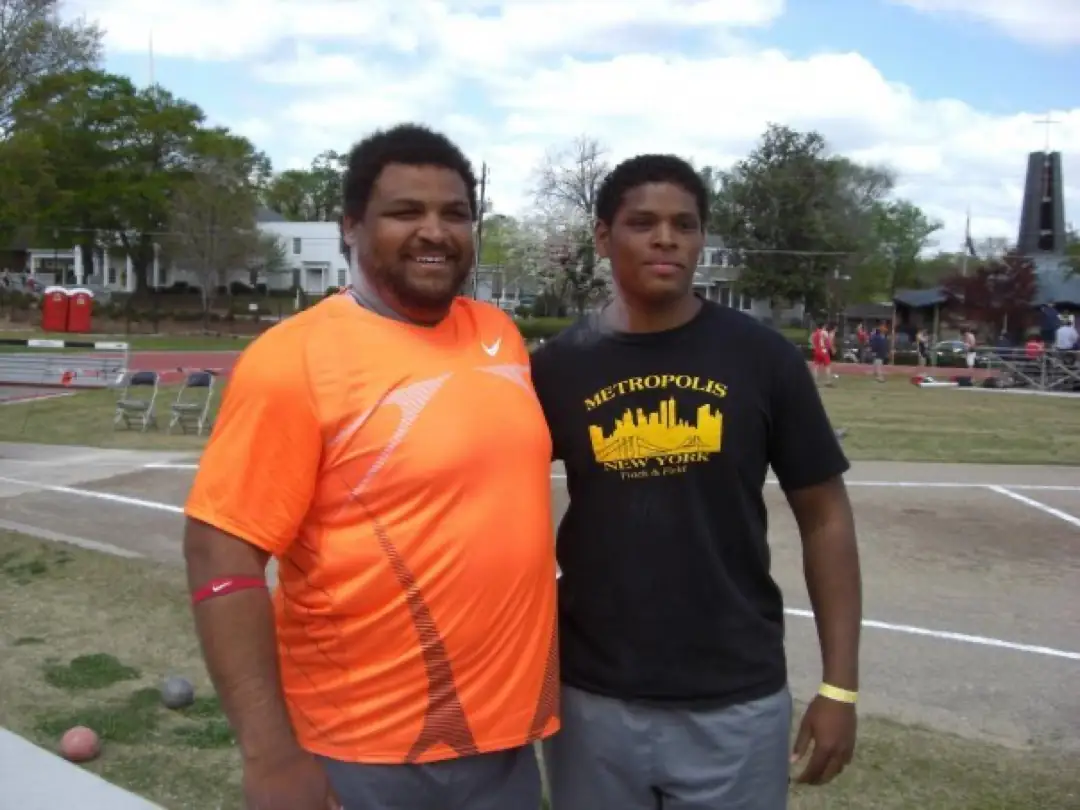 Metropolis alumnus Louis Day standing with 2006 World Champion shot putter Reese Hoffa.