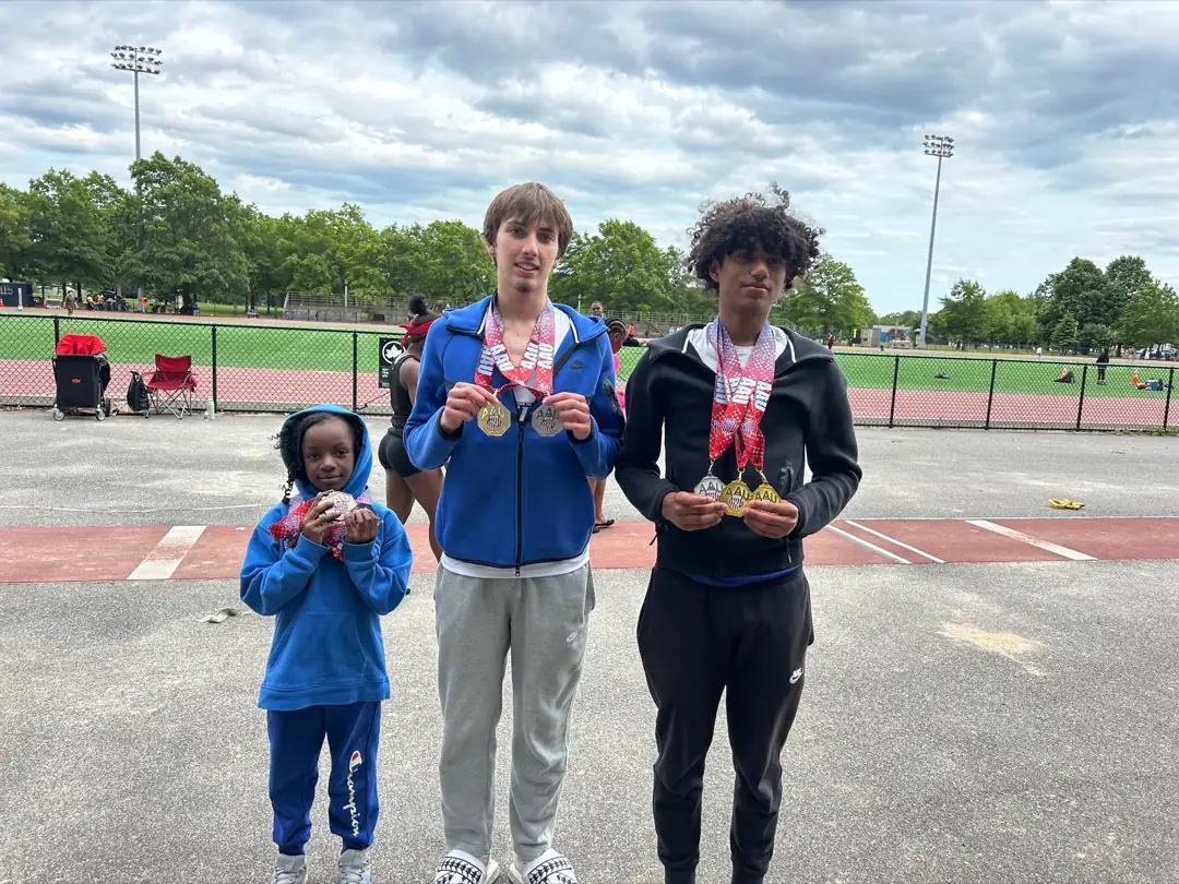 Metropolis athletes together at a track meet, wearing club uniforms and medals.